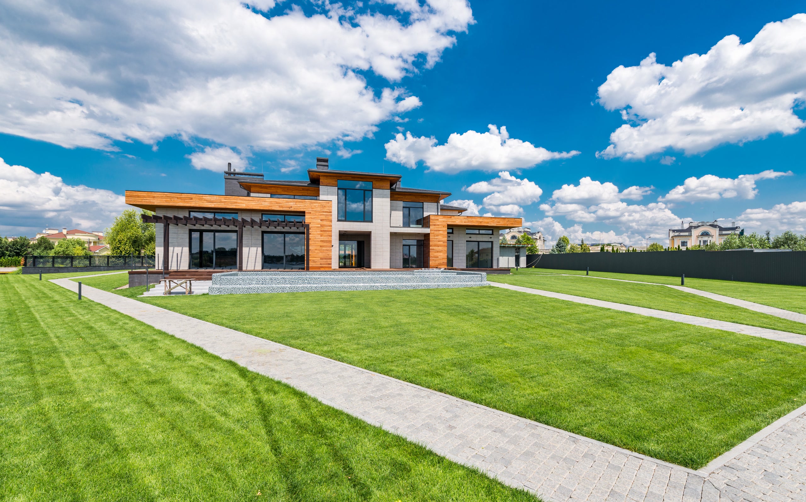 Modern home with timber accents across a wide lawn
